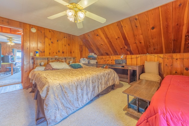 carpeted bedroom with access to exterior, wood walls, ceiling fan, and vaulted ceiling