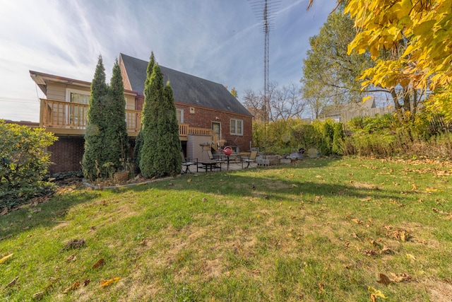 view of yard featuring a patio and a deck