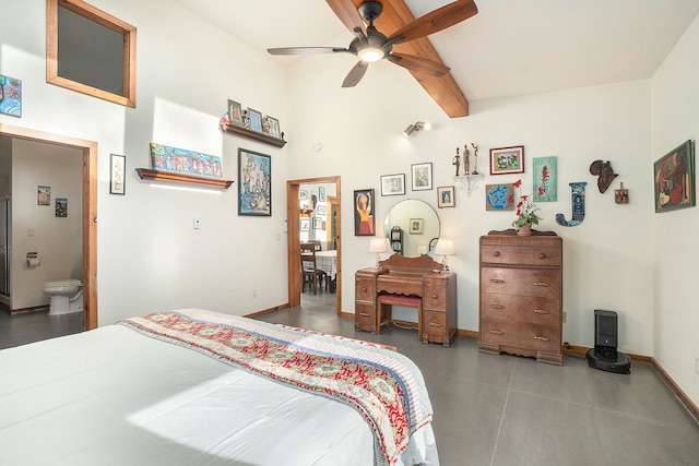 bedroom featuring beam ceiling, ceiling fan, ensuite bathroom, and a high ceiling