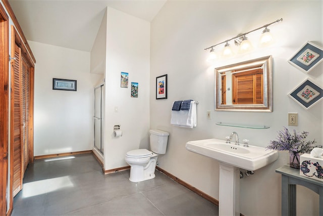 bathroom with toilet, an enclosed shower, and concrete floors