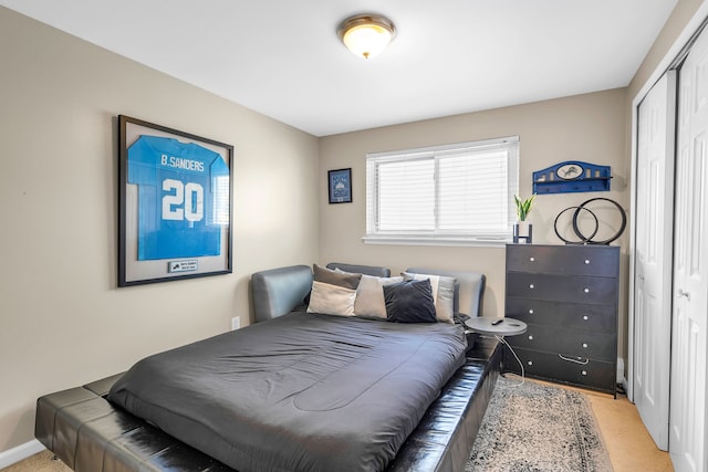 bedroom featuring light carpet and a closet