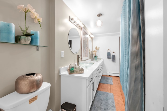 bathroom with toilet, tile patterned flooring, vanity, and a baseboard heating unit