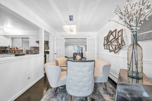 dining area featuring a baseboard heating unit, dark hardwood / wood-style flooring, and french doors