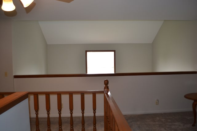 staircase with carpet floors and vaulted ceiling