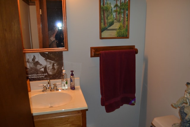 bathroom featuring vanity and toilet