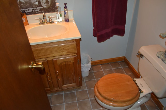 bathroom with toilet, tile patterned flooring, and vanity