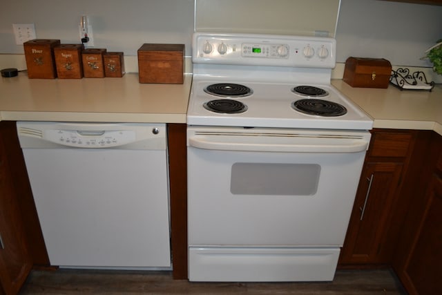 kitchen with white appliances and dark wood-type flooring