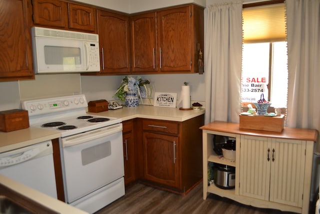 kitchen featuring white appliances and dark wood-type flooring