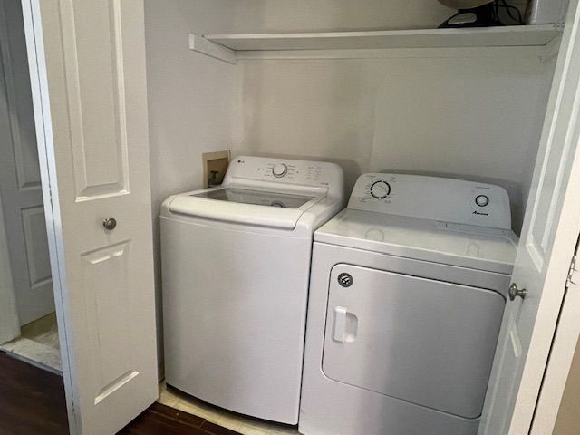 laundry area featuring dark hardwood / wood-style floors and separate washer and dryer