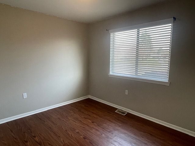 unfurnished room featuring dark hardwood / wood-style flooring