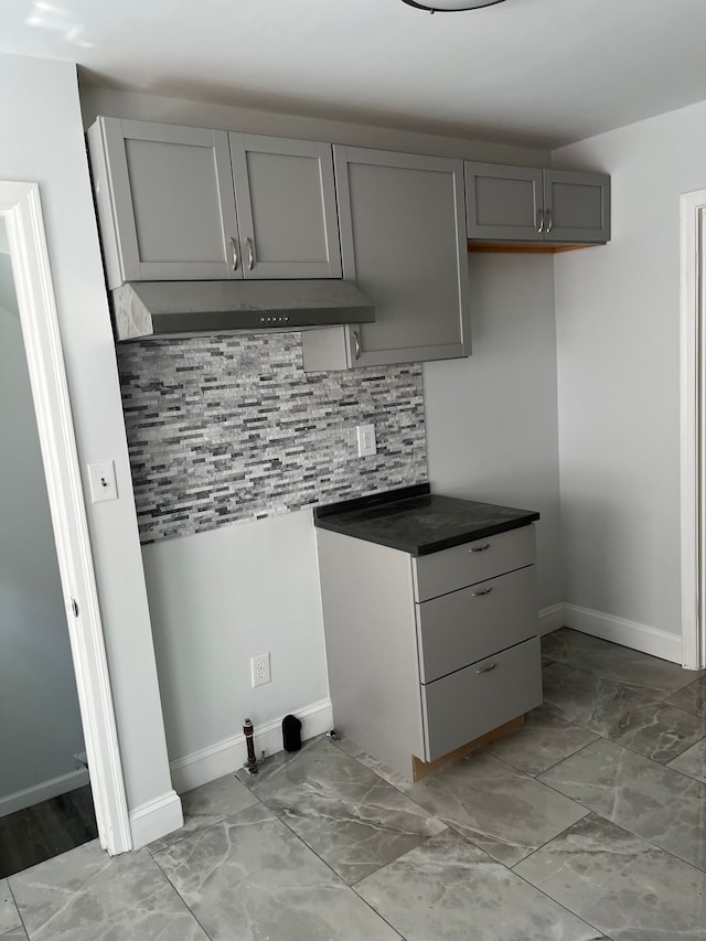 kitchen featuring backsplash and gray cabinetry