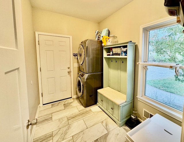 mudroom featuring stacked washing maching and dryer