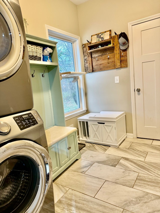 mudroom with stacked washing maching and dryer