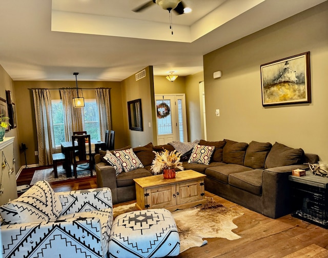 living room featuring ceiling fan and wood-type flooring