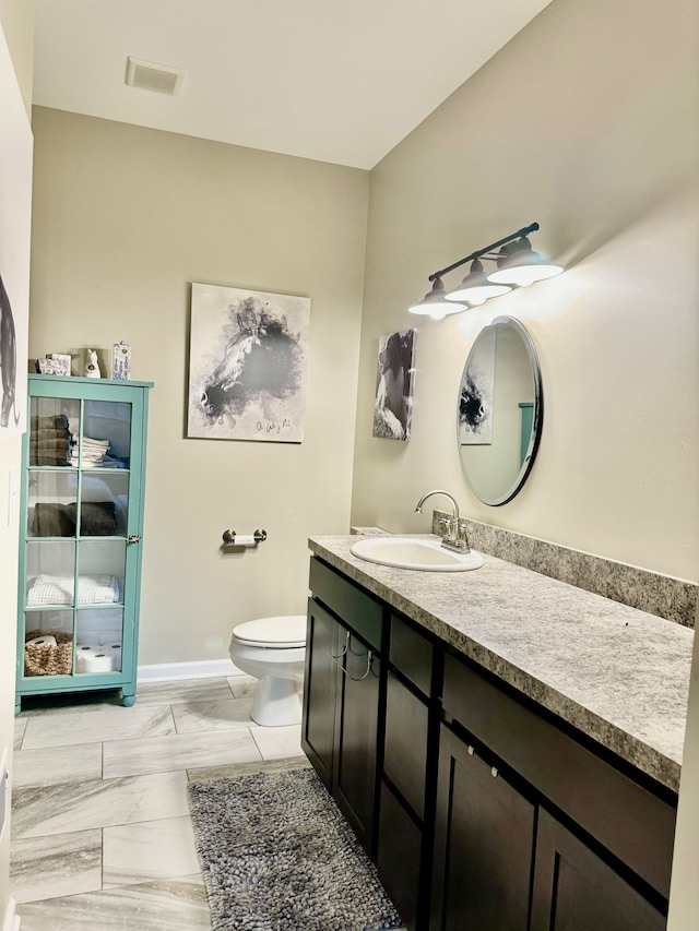 bathroom featuring vanity and toilet