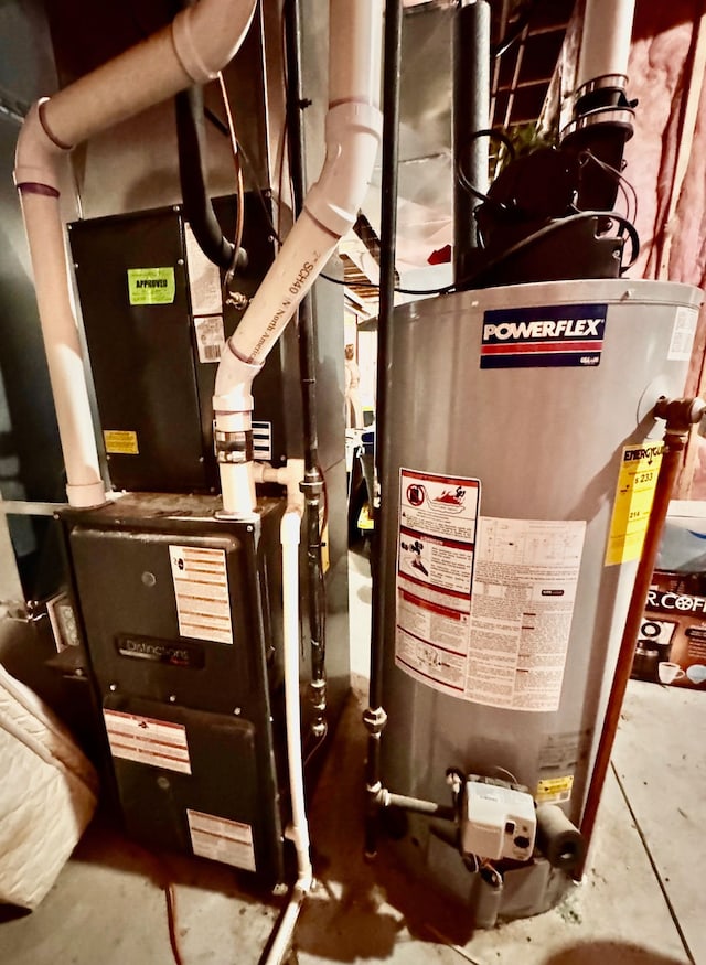 utility room featuring heating unit and water heater