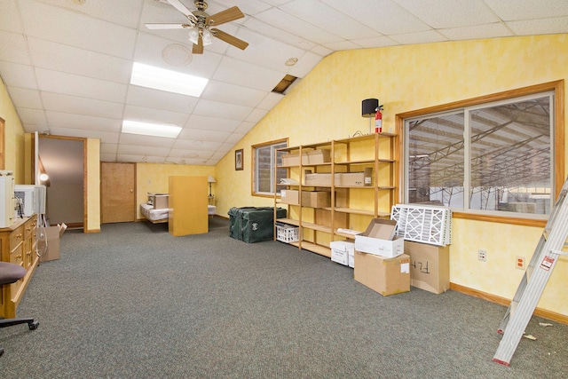 basement featuring carpet, a drop ceiling, and ceiling fan