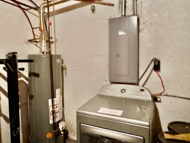 laundry room with electric panel, gas water heater, and washer / dryer