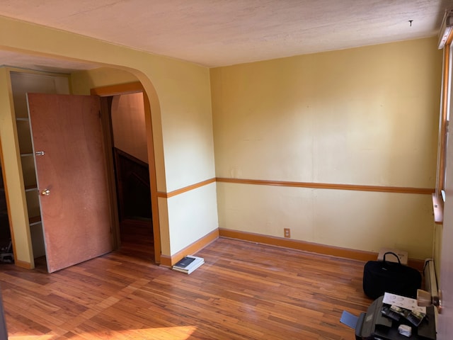 empty room with hardwood / wood-style floors