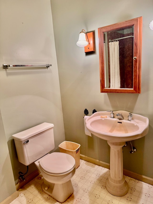 bathroom with a shower with curtain and toilet