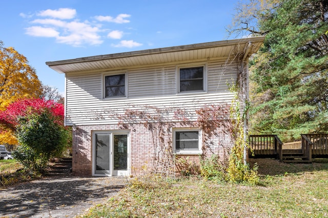 rear view of property with a wooden deck