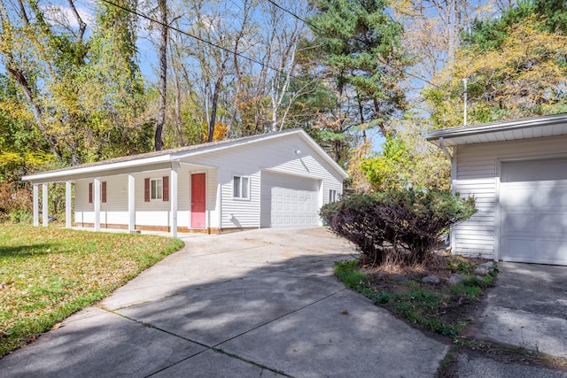 view of property exterior featuring covered porch, a yard, and a garage