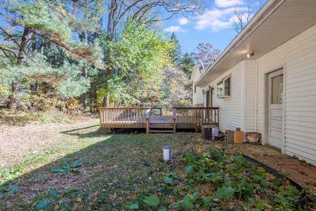 view of yard featuring cooling unit and a deck