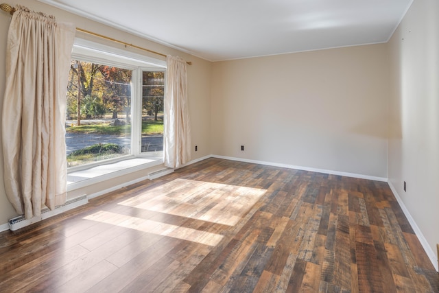 unfurnished room featuring dark hardwood / wood-style floors and ornamental molding