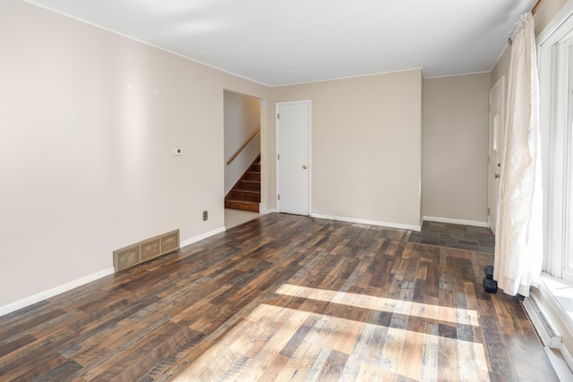 spare room with dark hardwood / wood-style floors and crown molding