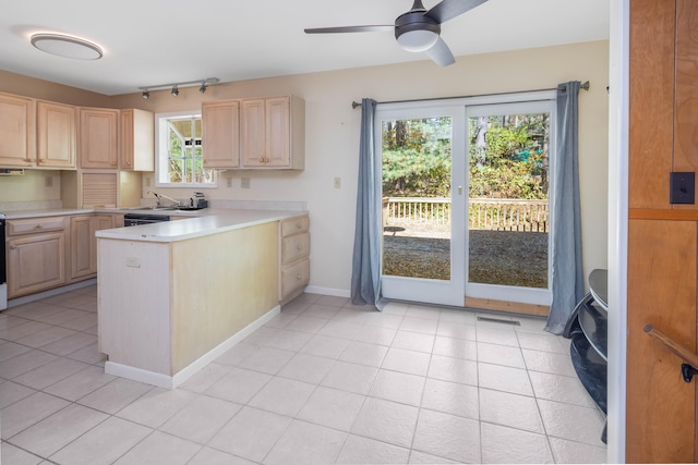 kitchen with light brown cabinets, sink, ceiling fan, light tile patterned flooring, and kitchen peninsula