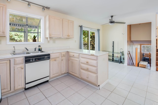 kitchen featuring ceiling fan, dishwasher, sink, kitchen peninsula, and light tile patterned floors