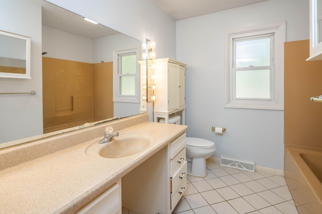 full bathroom with toilet, vanity, tile patterned floors, and a wealth of natural light