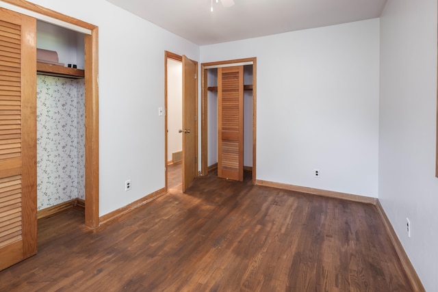 unfurnished bedroom with a closet and dark wood-type flooring