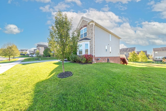 view of side of home featuring a lawn