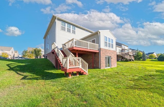 back of property featuring a lawn and a wooden deck