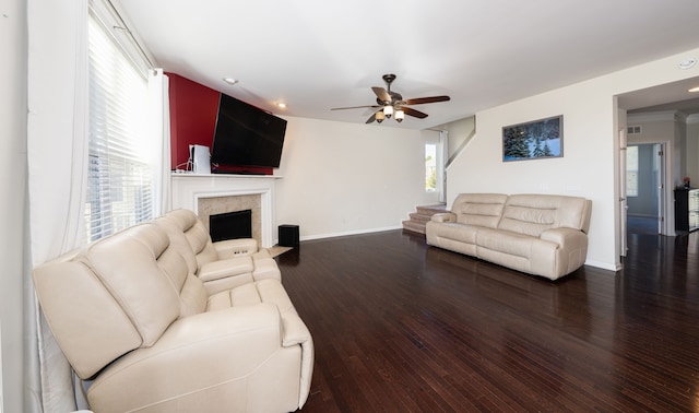 living room featuring ceiling fan and dark wood-type flooring