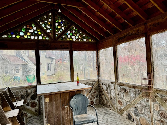 sunroom / solarium with lofted ceiling with beams