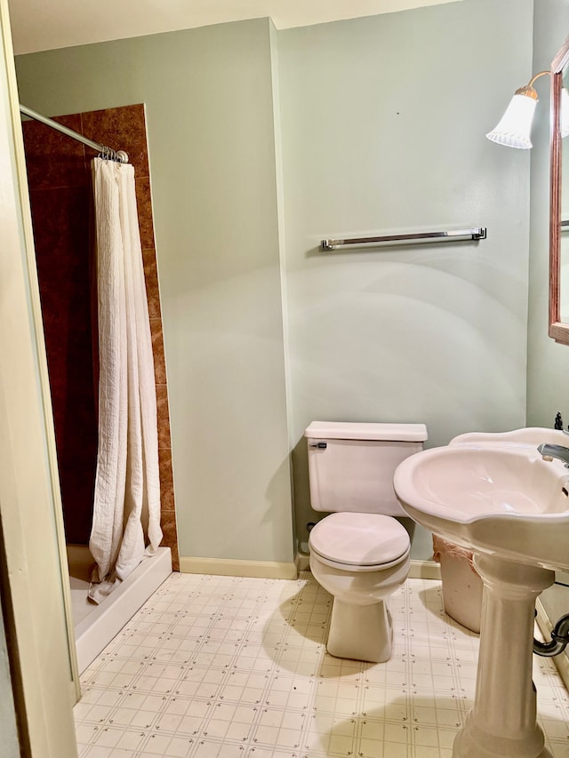 bathroom with a shower with curtain and toilet