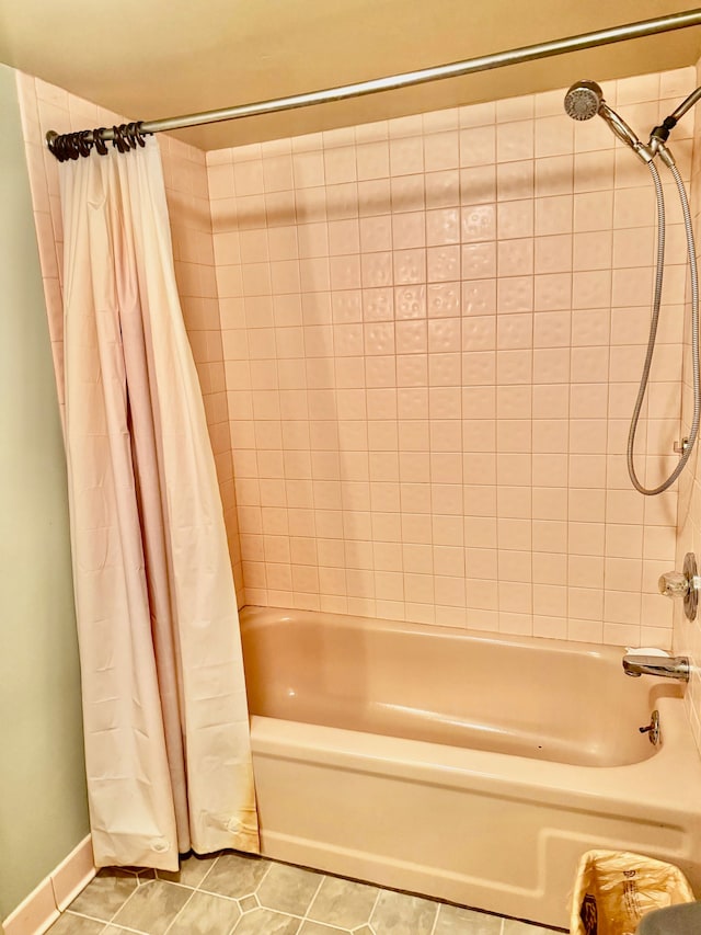 bathroom featuring tile patterned flooring and shower / bath combo