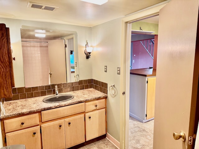 bathroom with tile patterned flooring and vanity