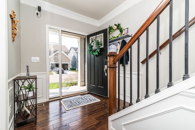 foyer featuring dark hardwood / wood-style flooring, crown molding, and a healthy amount of sunlight