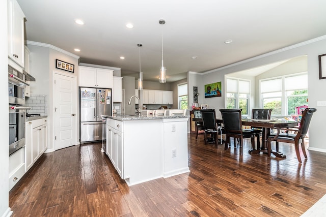 kitchen featuring white cabinetry, a center island with sink, decorative backsplash, dark wood-type flooring, and stainless steel refrigerator