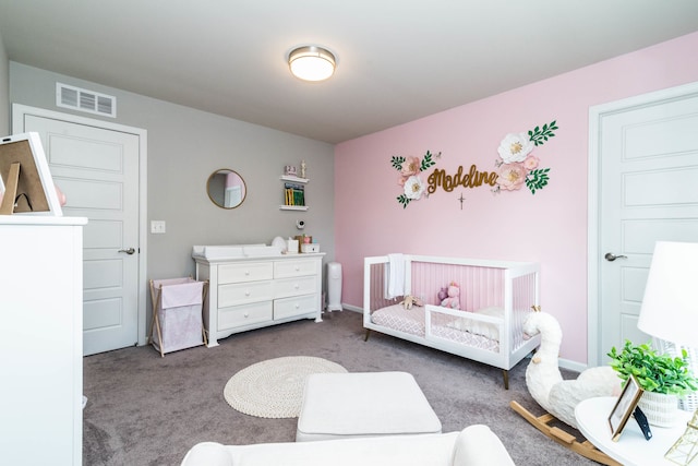 carpeted bedroom featuring a nursery area