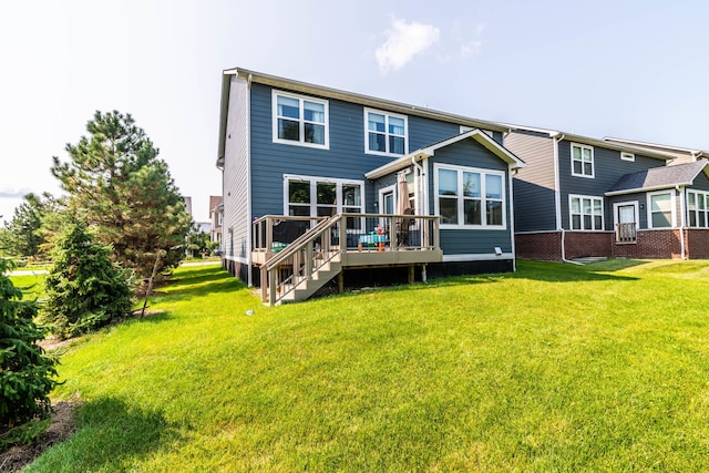 rear view of property with a deck and a yard