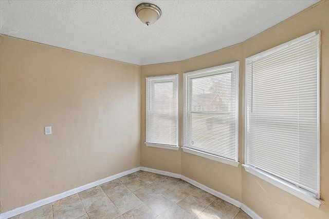 empty room featuring a textured ceiling