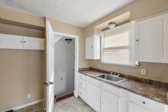 kitchen with white cabinetry and sink