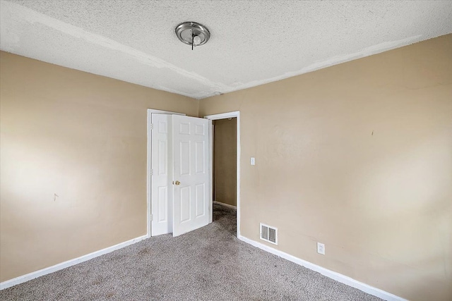 unfurnished bedroom with carpet flooring and a textured ceiling