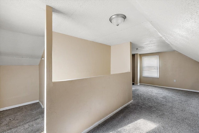 bonus room featuring carpet, a textured ceiling, and vaulted ceiling