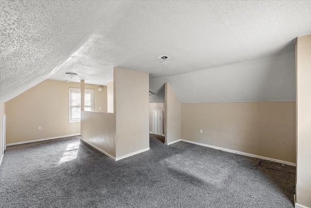 bonus room with dark colored carpet, a textured ceiling, and lofted ceiling