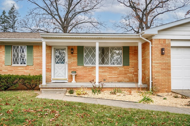 doorway to property with a porch and a garage